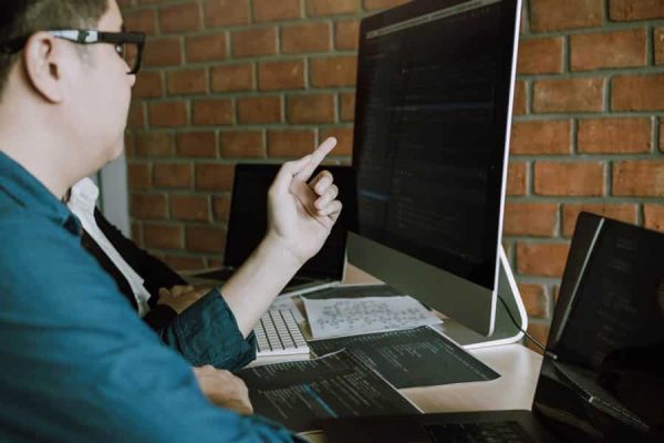 Developing programming and coding technologies working in a software engineers developing applications together in office.